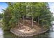 Beautiful wooded home featuring an outdoor patio area with lake access and waterfront views at 121 Rhinehill Dr, Mooresville, NC 28117