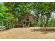 Beautiful exterior view of home's facade and spacious landscaped yard with mature trees at 121 Rhinehill Dr, Mooresville, NC 28117