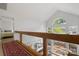 Bright hallway with soaring ceilings, natural light, and glass railings overlooking below at 121 Rhinehill Dr, Mooresville, NC 28117