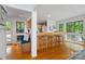 Eat-in kitchen features breakfast bar with seating, wood floors, and bright natural light at 121 Rhinehill Dr, Mooresville, NC 28117