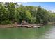 Beautiful lakefront view with boat dock featuring lakeside lounging area with seating and deck access at 121 Rhinehill Dr, Mooresville, NC 28117