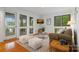 Cozy living room featuring white walls, plush seating, and views of outdoor deck through large glass windows at 121 Rhinehill Dr, Mooresville, NC 28117