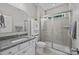 Bathroom with granite countertops, white cabinets, and a glass enclosed shower with tile surround at 12619 Old Westbury Dr, Cornelius, NC 28031