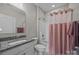 Bathroom with a tub and shower combo and a granite countertop at 12619 Old Westbury Dr, Cornelius, NC 28031