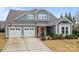 Beautiful two-story home featuring a two-car garage, well-manicured lawn, and lovely curb appeal at 12619 Old Westbury Dr, Cornelius, NC 28031