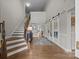 Spacious foyer with hardwood floors, a staircase, and sliding glass doors leading to another room at 12619 Old Westbury Dr, Cornelius, NC 28031