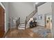 Bright foyer features hardwood floors, a staircase with iron spindles, and a decorative rug at 12619 Old Westbury Dr, Cornelius, NC 28031