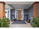 Inviting front porch with comfortable seating, a stylish rug, and an elegant wooden front door at 12619 Old Westbury Dr, Cornelius, NC 28031