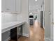 View of the kitchen with island, desk, wine cooler, and stainless steel refrigerator at 12619 Old Westbury Dr, Cornelius, NC 28031