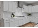 Bright kitchen featuring white cabinets, subway tile backsplash, and stainless steel hood at 12619 Old Westbury Dr, Cornelius, NC 28031