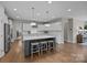 Open kitchen boasts large island, stainless steel appliances, and ample cabinet space at 12619 Old Westbury Dr, Cornelius, NC 28031