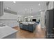 Open kitchen showcasing a large island with a farmhouse sink and stainless steel appliances at 12619 Old Westbury Dr, Cornelius, NC 28031