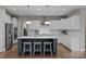 Spacious kitchen with stainless steel appliances, white cabinets, and pendant lighting at 12619 Old Westbury Dr, Cornelius, NC 28031
