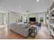 Bright living room with hardwood floors, fireplace, and large windows at 12619 Old Westbury Dr, Cornelius, NC 28031