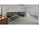 Living room featuring a dark leather sectional sofa and neutral carpet at 12619 Old Westbury Dr, Cornelius, NC 28031