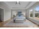 Bright main bedroom with large windows, hardwood floors, and a ceiling fan at 12619 Old Westbury Dr, Cornelius, NC 28031