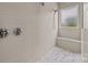 Walk-in shower featuring stone tile floors, neutral tile walls, a built-in bench, and dual shower heads at 12619 Old Westbury Dr, Cornelius, NC 28031