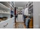 Organized walk-in closet featuring built-in shelves, drawers, and hanging rods at 12619 Old Westbury Dr, Cornelius, NC 28031