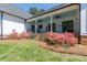 A view of the home's backyard, showcasing the landscaping and a charming patio at 1300 Aragon Beach Rd, Rock Hill, SC 29732