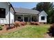 A view of the backyard landscaping, with a covered patio and manicured lawn at 1300 Aragon Beach Rd, Rock Hill, SC 29732