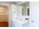 Elegant bathroom with bright white vanity, shelving, mirror, and walk-in closet at 1300 Aragon Beach Rd, Rock Hill, SC 29732