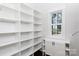 Walk-in closet boasts built in shelving and cabinetry at 1300 Aragon Beach Rd, Rock Hill, SC 29732