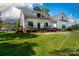 Stunning two-story home featuring black trim, a charming front porch, and lush green lawn at 1300 Aragon Beach Rd, Rock Hill, SC 29732