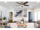 Bright living room features a decorative ceiling fan and built-in cabinets for storage and organization at 1300 Aragon Beach Rd, Rock Hill, SC 29732