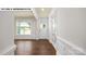 Bright foyer features hardwood floors, natural light from window and white door, and classic paneled trim at 134 Asmodean Ln, Troutman, NC 28166