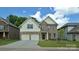 Beautiful two-story brick home with a two-car garage and well-manicured lawn at 136 Asmodean Ln, Troutman, NC 28166