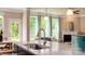 Granite kitchen island with pendant lights and view of the living room at 136 Asmodean Ln, Troutman, NC 28166