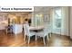 Elegant dining room next to kitchen area featuring modern lighting and hardwood floors at 140 Asmodean Ln, Troutman, NC 28166