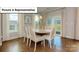 Elegant dining room with wood floors, neutral walls, and a view to the outside at 140 Asmodean Ln, Troutman, NC 28166