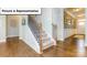 Inviting foyer showcasing the staircase, beautiful wood floors, and trim work detail throughout at 140 Asmodean Ln, Troutman, NC 28166