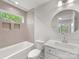 Bright bathroom with tiled shower-tub, white vanity, and neutral wall color, creating a spa-like atmosphere at 1413 Kenilworth Ave, Charlotte, NC 28203
