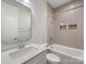 Modern bathroom with white vanity, sleek fixtures, and a tiled shower-tub combo, ensuring a clean and functional space at 1413 Kenilworth Ave, Charlotte, NC 28203