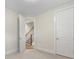 Neutral bedroom with carpet, white walls, and entry to staircase, providing a blank canvas for personal touches at 1413 Kenilworth Ave, Charlotte, NC 28203