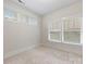 Bright, carpeted bedroom with multiple windows and neutral walls, offering a cozy and serene atmosphere at 1413 Kenilworth Ave, Charlotte, NC 28203