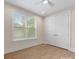 Bedroom featuring hardwood floors, baseboard trim, recessed lights, large window and closet at 1413 Kenilworth Ave, Charlotte, NC 28203