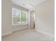 Bedroom featuring carpet, baseboard trim, recessed lights, a window, and bathroom access at 1413 Kenilworth Ave, Charlotte, NC 28203