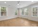 Bright bedroom with hardwood floors, multiple windows, and neutral paint at 1413 Kenilworth Ave, Charlotte, NC 28203