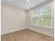 Neutral bedroom featuring hardwood floors, baseboard trim, recessed lights and a large window at 1413 Kenilworth Ave, Charlotte, NC 28203