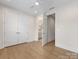 Bedroom featuring hardwood floors, baseboard trim, recessed lights, double closet, and bathroom access at 1413 Kenilworth Ave, Charlotte, NC 28203