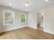 Bonus room featuring hardwood floors, natural light, and an adjacent bathroom offering comfort and convenience at 1413 Kenilworth Ave, Charlotte, NC 28203