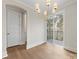 Bright dining area with hardwood floors, modern chandelier, sliding door access to balcony and natural light at 1413 Kenilworth Ave, Charlotte, NC 28203