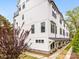 Stylish white townhouse complex with modern design elements and well-manicured lawns, offering a sophisticated living experience at 1413 Kenilworth Ave, Charlotte, NC 28203