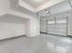 Spacious garage with speckled floor and white walls; garage door with windows at 1413 Kenilworth Ave, Charlotte, NC 28203