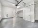 Spacious garage with speckled floor, storage space, garage door opener, and interior access door at 1413 Kenilworth Ave, Charlotte, NC 28203
