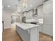 Modern kitchen with white cabinets, marble counters, stainless steel appliances, and pendant lighting at 1413 Kenilworth Ave, Charlotte, NC 28203
