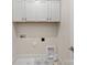 Laundry room featuring tile floors, white cabinets and utility connections at 1413 Kenilworth Ave, Charlotte, NC 28203